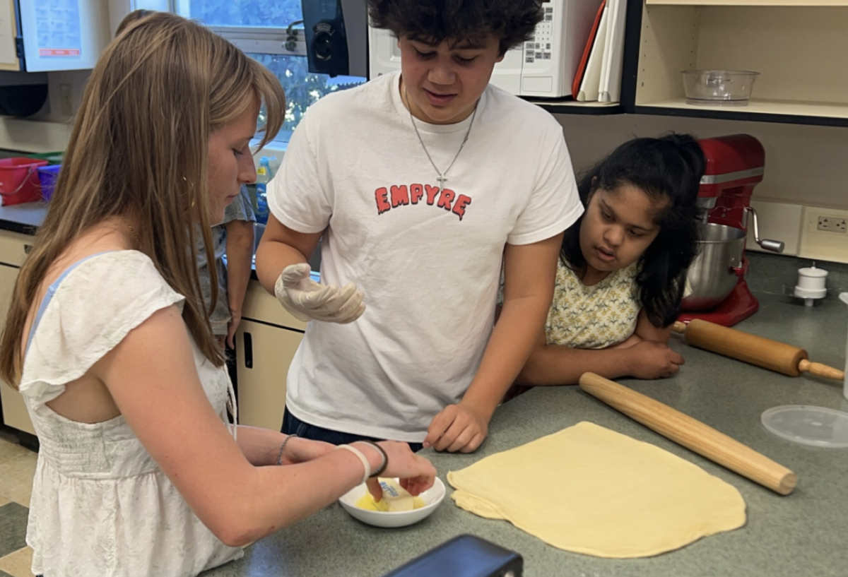 The students were hard at work in preparations for baking the rolls.